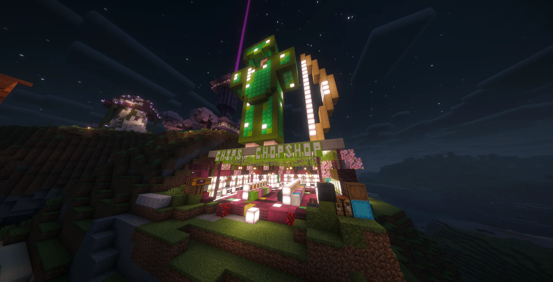The illuminated Chops Shop statue and storefront at night